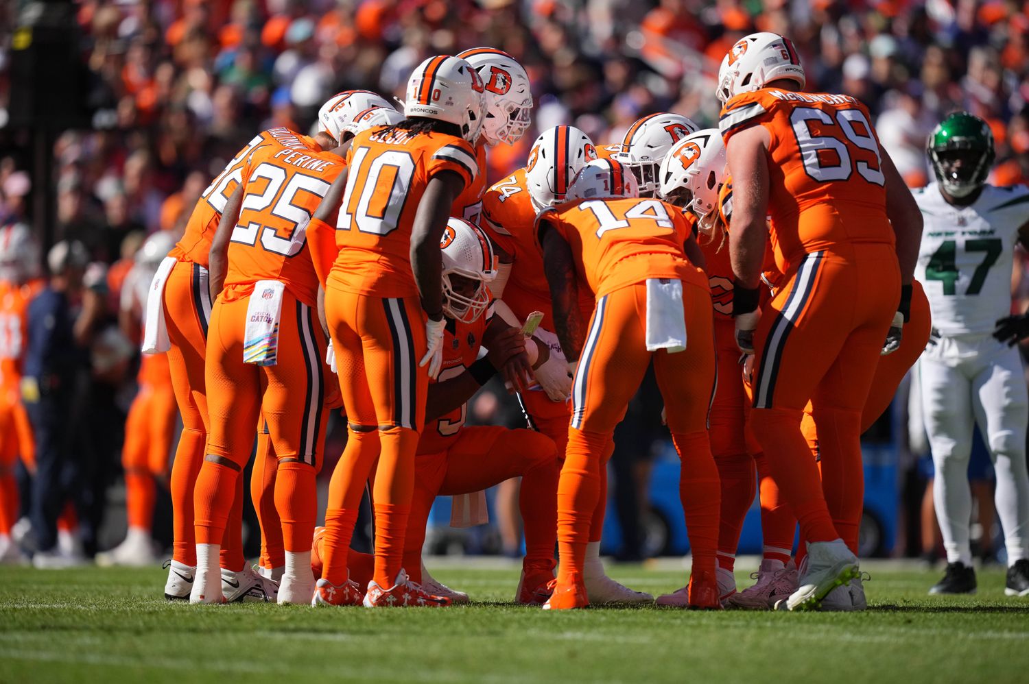 Oct 8, 2023; Denver, Colorado, USA; Denver Broncos quarterback Russell Wilson (3) (center) huddles with teammates in the first quarter against the New York Jets at Empower Field at Mile High. Mandatory Credit: Ron Chenoy-USA TODAY Sports